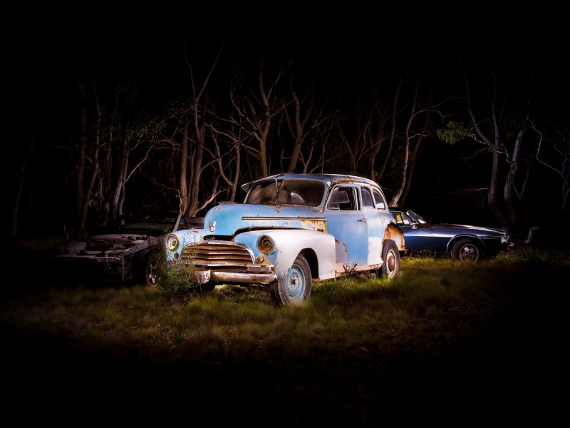 Automotive photography of 1950's Chevrolet and XJS Jag at Night